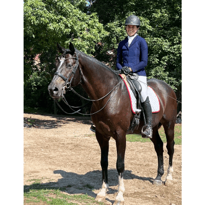 A woman is sitting on top of her horse.